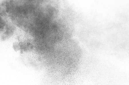 Black particles explosion isolated on white background.  Abstract dust overlay texture.の写真素材