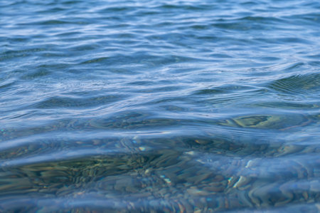 Blue sea surface with waves. Abstract background of water flow in ocean, sea, river, lake. Seascape wallpaper.の写真素材