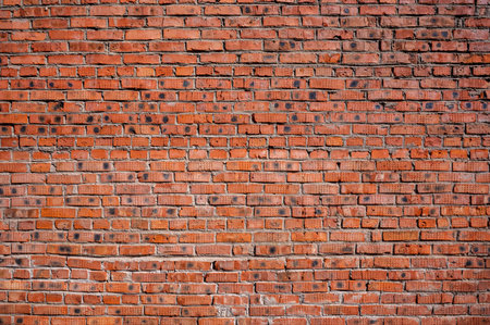 Red brick wall background. Old brickwork texture. Rock block pattern. Vintage stonewall. Abstract grunge urban design. Textured surface building.の写真素材