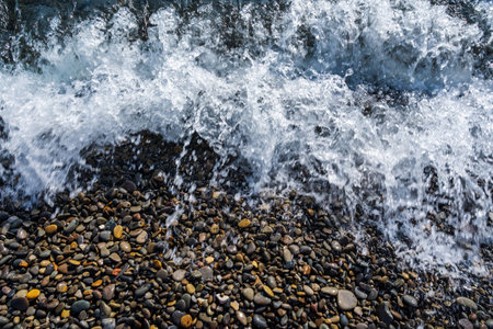 Water sea beach. Wave ocean blue. Stone texture reflection sun. Surface coast pebbles. Abstract...