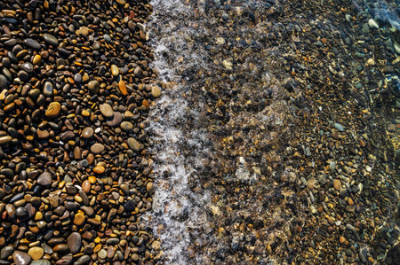 Water sea beach. Wave ocean blue. Stone texture reflection sun. Surface coast pebbles. Abstract light rock background.の写真素材