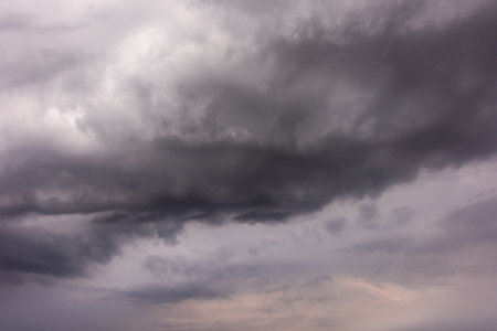 Blue sky dark clouds. Dramatic cloud during rain, thunderstorm, storm. Nature moody cloudscape.の写真素材