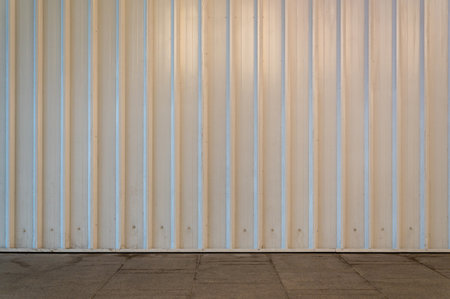 Fragment of empty street city, white wall of fence and pavement. Building faÃ§ade. Mockup or background for creativity. Place for advertising, banner, billboard, announcement, poster.の写真素材