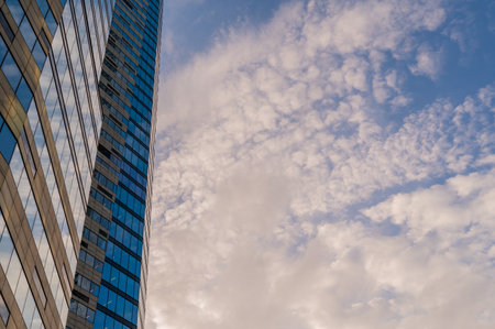 Angled view of modern skyscrapers in business district against blue sky. Looking Up high-rise office buildings.の写真素材