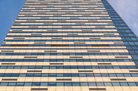 Angled view of modern skyscrapers in business district against blue sky. Looking Up high-rise office buildings.の写真素材