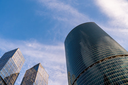 Angled view of modern skyscrapers in business district against blue sky. Looking Up high-rise office buildings.の写真素材