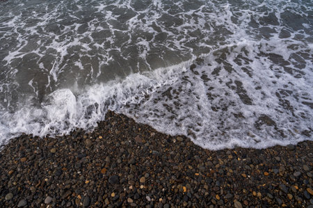 Sea beach. Wave ocean blue. Water splash texture. Surface coast pebbles.の写真素材