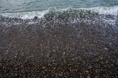 Sea beach. Wave ocean blue. Water splash texture. Surface coast pebbles.の写真素材