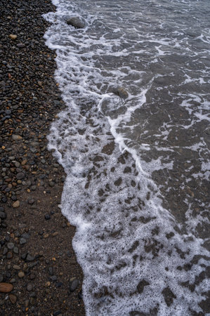 Sea beach. Wave ocean blue. Water splash texture. Surface coast pebbles.の写真素材