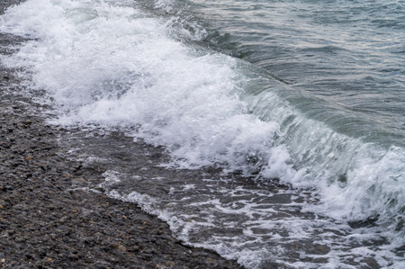 Sea beach. Wave ocean blue. Water splash texture. Surface coast pebbles.の写真素材
