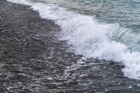 Sea beach. Wave ocean blue. Water splash texture. Surface coast pebbles.の写真素材