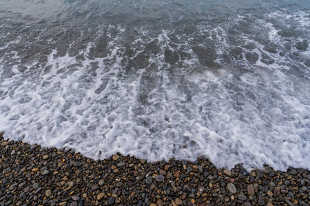 Sea beach. Wave ocean blue. Water splash texture. Surface coast pebbles.の写真素材