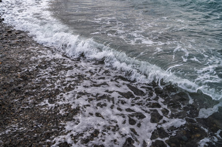 Sea beach. Wave ocean blue. Water splash texture. Surface coast pebbles.の写真素材