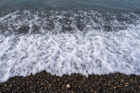 Sea beach. Wave ocean blue. Water splash texture. Surface coast pebbles.の写真素材