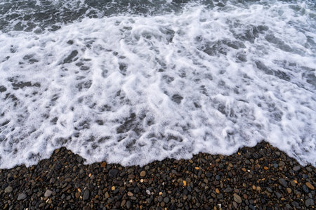 Sea beach. Wave ocean blue. Water splash texture. Surface coast pebbles.の写真素材