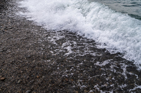 Sea beach. Wave ocean blue. Water splash texture. Surface coast pebbles.の写真素材