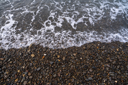 Sea beach. Wave ocean blue. Water splash texture. Surface coast pebbles.の写真素材
