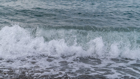 Sea beach. Wave ocean blue. Water splash texture. Surface coast pebbles.の写真素材