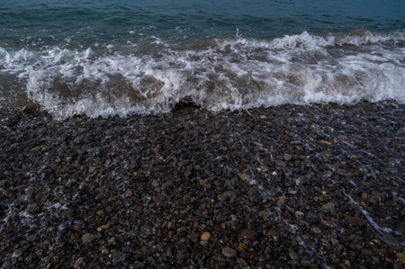 Sea beach. Wave ocean blue. Water splash texture. Surface coast pebbles.の写真素材