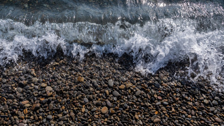 Sea beach. Wave ocean blue. Water splash texture. Surface coast pebbles.の写真素材