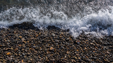 Sea beach. Wave ocean blue. Water splash texture. Surface coast pebbles.の写真素材