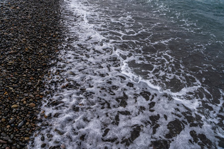 Sea beach. Wave ocean blue. Water splash texture. Surface coast pebbles.の写真素材