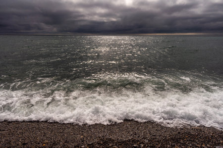 Dark storm clouds over ocean. Dramatic seascape. Clouds and rain flurry over sea.の写真素材