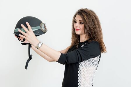 Fashion portrait of sexy stunning hipster woman, bright make up, vintage sunglasses, biker leather jacket, trendy jewelry and accessorizes. Urban wall background. Photoshoot relaxed bikerの写真素材