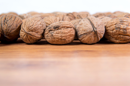 A lot of scattered walnuts close-up. A useful product.の写真素材