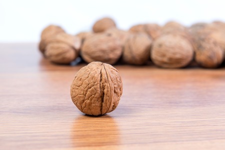 A lot of scattered walnuts close-up. A useful product.の写真素材