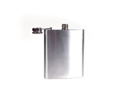 Stainless hip flask isolated on a white background. Alcohol addiction.の写真素材