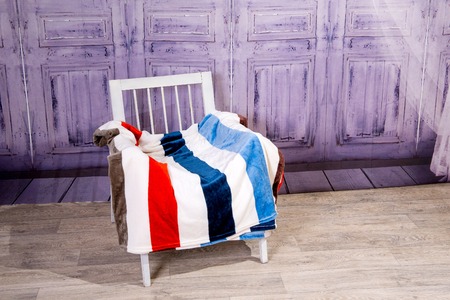 Wooden white chair covered with colored plaid tepym.の写真素材