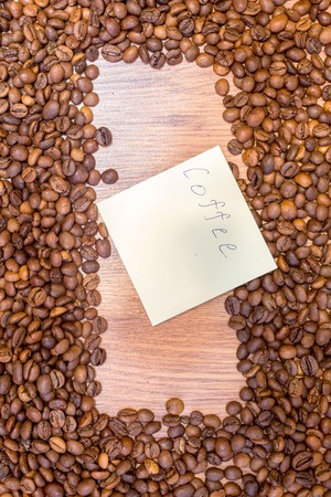 Spilled grains of fragrant coffee close-up. Photo frame, background.の写真素材