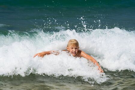 Summer joy. Little boy bathing on the seaの写真素材