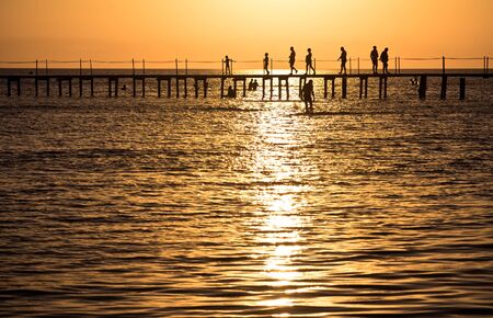 People on the pier at duskの写真素材