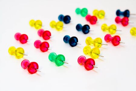 Colorful office pins on white background