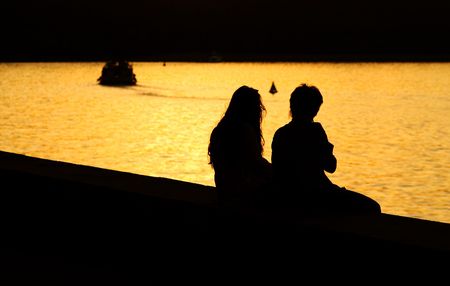 Silhouette of Young Couple at Sunsetの写真素材