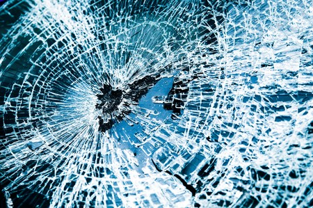 Close-up at broken car windshield. Tint blue