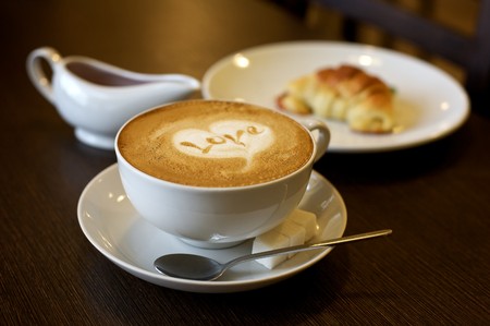 Coffee cup with milk and heart shape (selective DOF)の写真素材