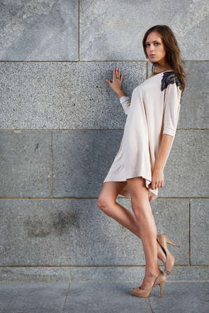 Young beautiful woman against a stone wallの写真素材