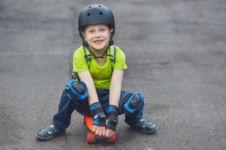 Boy in helmet posing with skateboardの写真素材