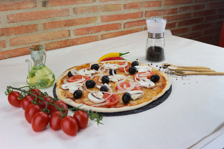 fresh pizza product on tableの写真素材