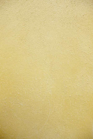 Yellow texture background, detail of yellow wall in the city, urban decorationの写真素材