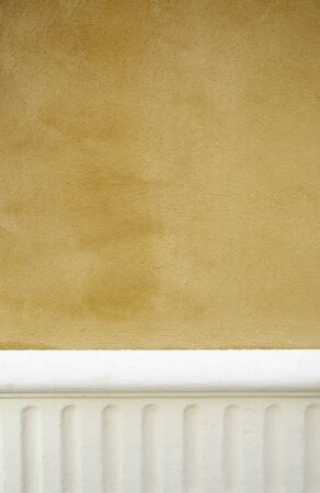 Yellow wall decorated detail details exterior wall with white, urban decorationの写真素材