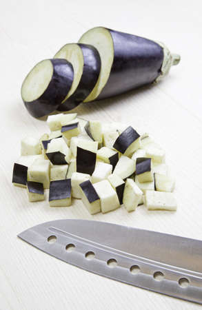 Eggplant and knife, detail of preparation of the plant, raw food in the kitchen, healthy eatingの写真素材
