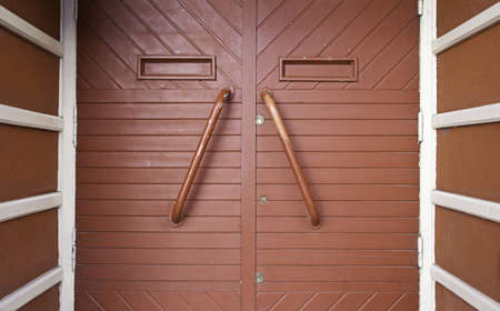 Red wooden door, detail of a closed door in the city, detail of decoration in the city, wooden textured backgroundの写真素材