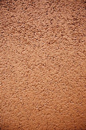 Red background with texture detail of a painted wall in the city, red rough textureの写真素材