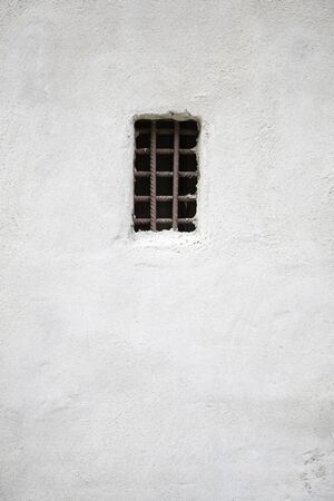 Old window in the wall, concrete wall detail with a window pequela, exploration in the cityの写真素材