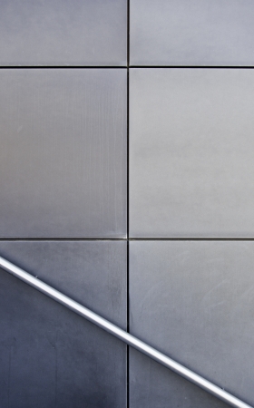 Railing against the wall, detail of a railing on a wall of tiles, architectural backgroundの写真素材