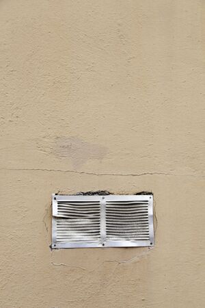 Facade with metal grille, detail of a damaged grille on a facade in the city, textured background,...